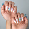Side view of ocean-inspired almond nails with sculpted shell designs and luxe gold details