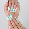 Fingers splayed to display intricate ocean-inspired long pipe nails with 3D flowers and metallic starfish by Naillover
