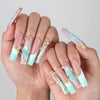 Pose highlighting sculptural pipe nails with sea wave textures, pastel blooms, and golden starfish details by Naillover