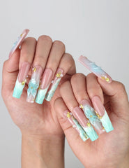 Pose highlighting sculptural pipe nails with sea wave textures, pastel blooms, and golden starfish details by Naillover