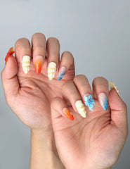 Side view of summer almond nails with beachy shell textures and bold tropical color palette