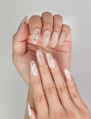 Close-up of Naillover Shimmering Beige Singapore press on nails showing cat eye nails design with delicate golden details.