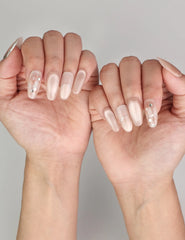 Naillover Shimmering Beige trendy nails styled on hand, featuring a beige cat eye glow with subtle foil accents.