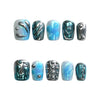 Product display of Naillover handmade short coffin blue nails with water droplet textures and chrome silver shine