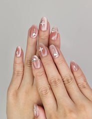 Hand wearing Naillover Silver Charm handmade press on nails with glossy cat eye finish and silver butterfly charms.