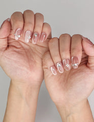 Naillover Silver Charm trendy nails styled on hand, featuring handmade glossy press on nails with silver butterfly charms.