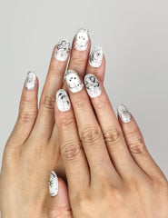 Hand wearing Naillover Silver Starry Cutie handmade press on nails with galaxy-inspired design, bunny, and star accents.