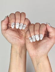 Naillover Silver Starry Cutie cute nails styled on hand, showcasing galaxy sparkle base with bunny and studded accents.