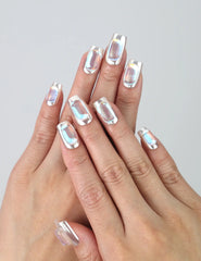 Hand gesture showing short-length silver press on nails with metallic chrome shine and gem accents by Naillover