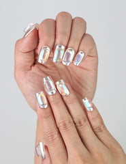 Fingers slightly curled to display Naillover’s Singapore handmade chrome silver nails with jewel embellishments