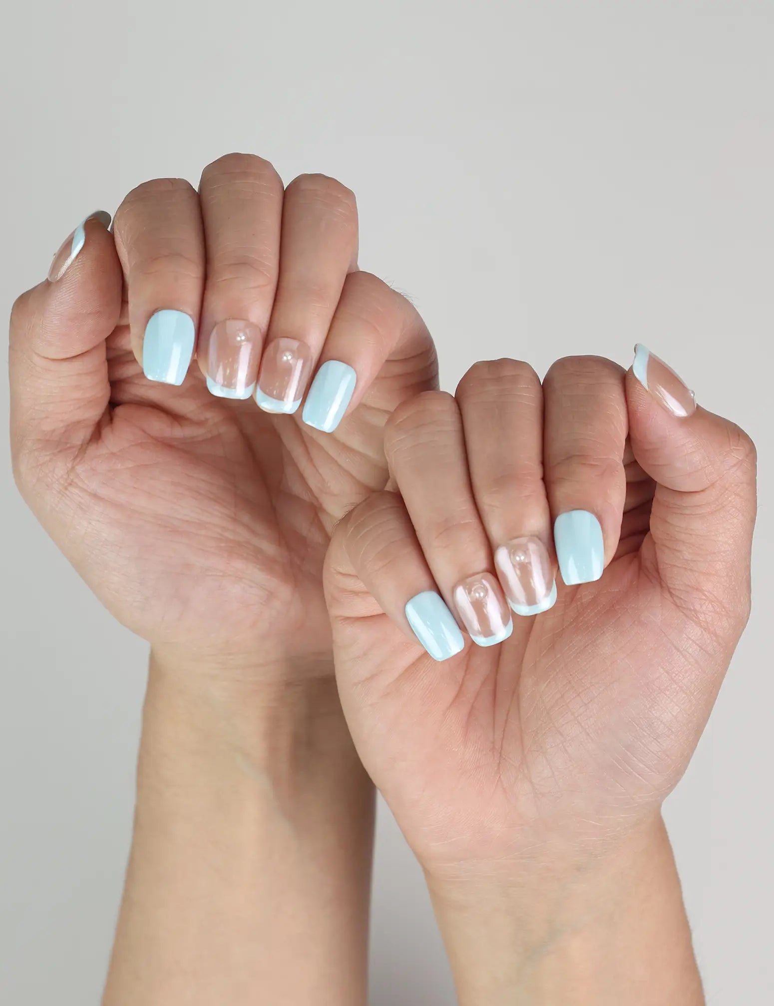 Skyline Singapore press on nails worn on both hands, glossy ombre blue design for trendy and classic style
