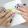 Hand holding a cup, showing playful press-on nails in bold colors and cute 3D accents