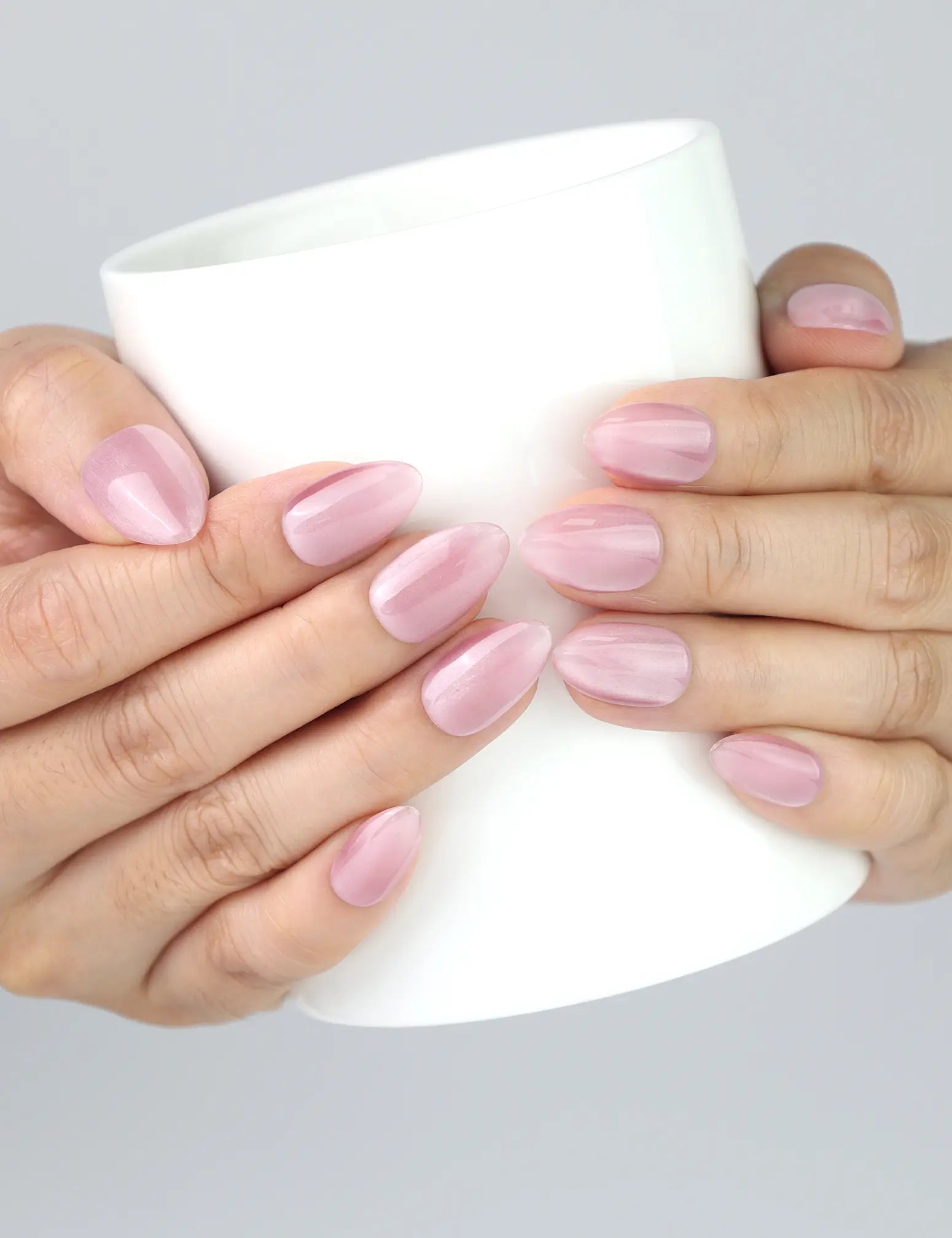 Hand holding a coffee cup with Soft Mirage Singapore press on nails by Naillover, feminine and relaxed vibe.