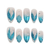 Product display of blue almond-shaped nails with glitter accents and shell patterns, perfect for a beachy summer look