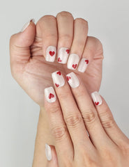 Close-up of naillover handmade Sparkle Love press on nails, sparkling white finish with romantic red hearts, trendy nails in Singapore.