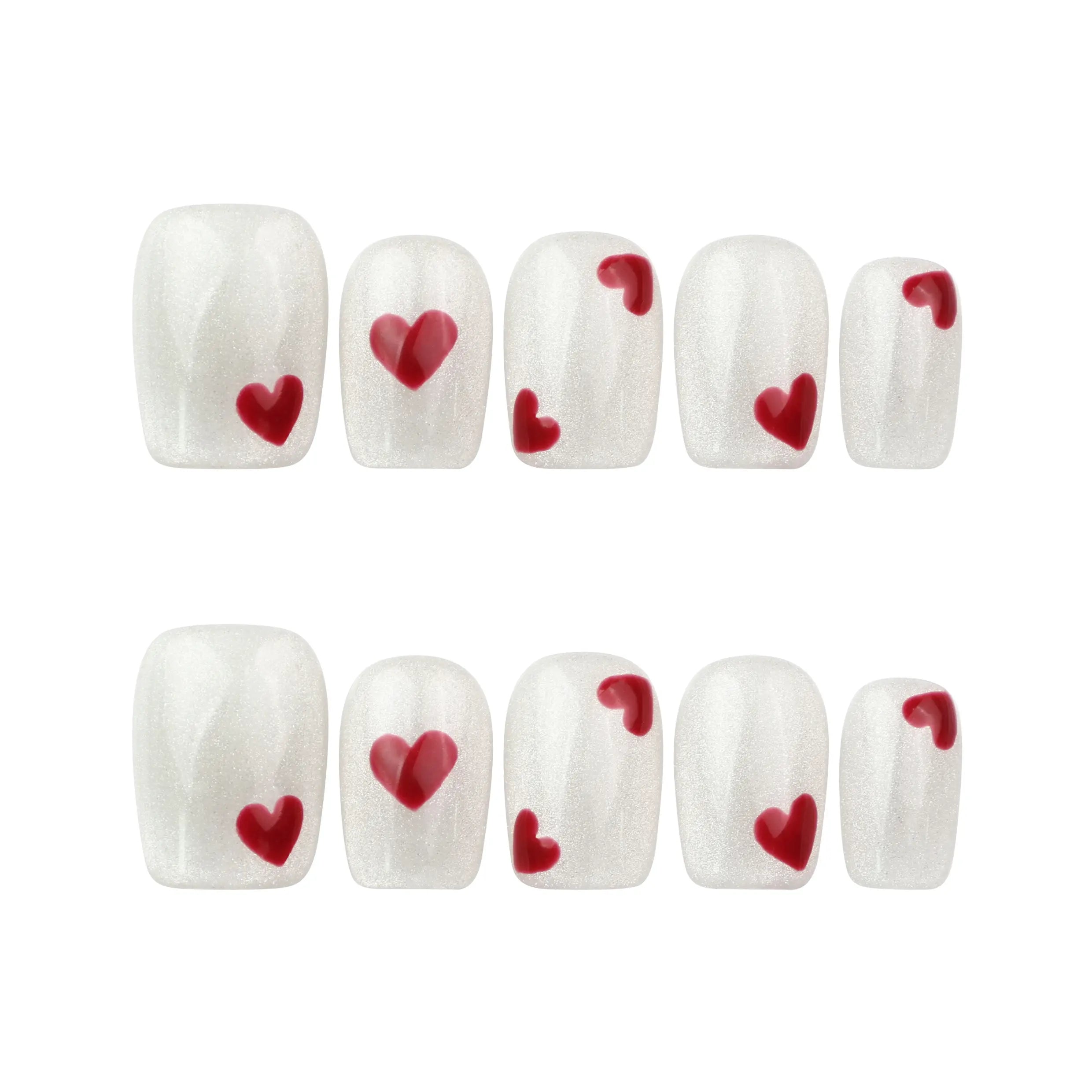 Flat lay of naillover Sparkle Love handmade press on nails set, white sparkle nails with bold red hearts, coquette and trendy nails design.