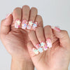Side view of handmade short coffin pink nails with shimmer glitter and raised starfish accents from Naillover Singapore