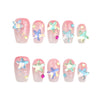 Product display of Naillover Singapore handmade pink press-on nails in short coffin shape with glitter and 3D starfish details