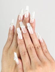Hand wearing Starlight Singapore press on nails with white base and silver star designs by naillover