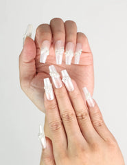 Close-up of fingers adorned with Starlight handmade Singapore press on nails featuring silver stars