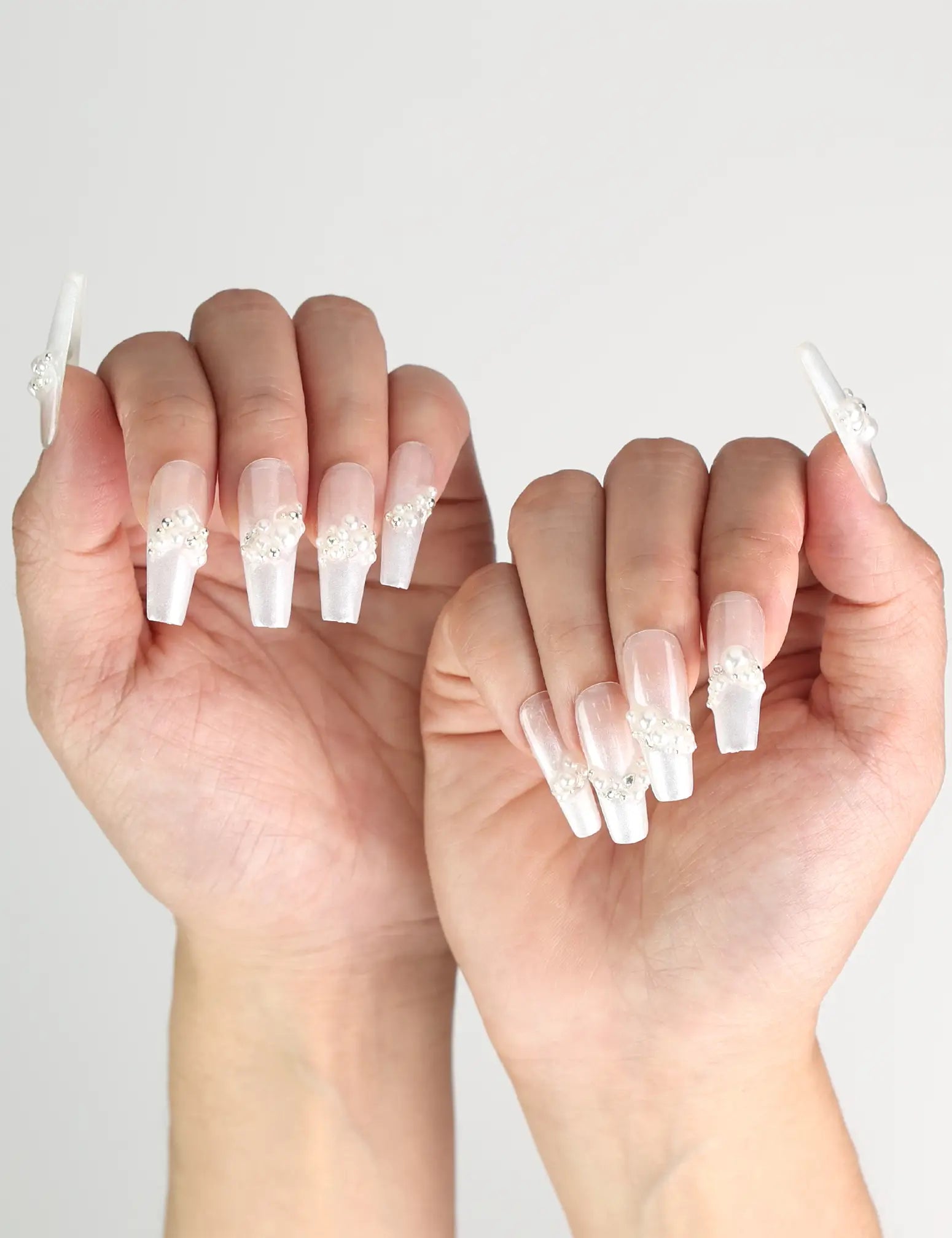 Elegant hand pose showing Starlight Singapore press on nails with crystal and star accents