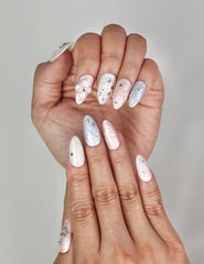Close-up of Naillover Starry Sweet Dream Singapore press on nails featuring cosmic pearlescent tones with rhinestones and heart details.