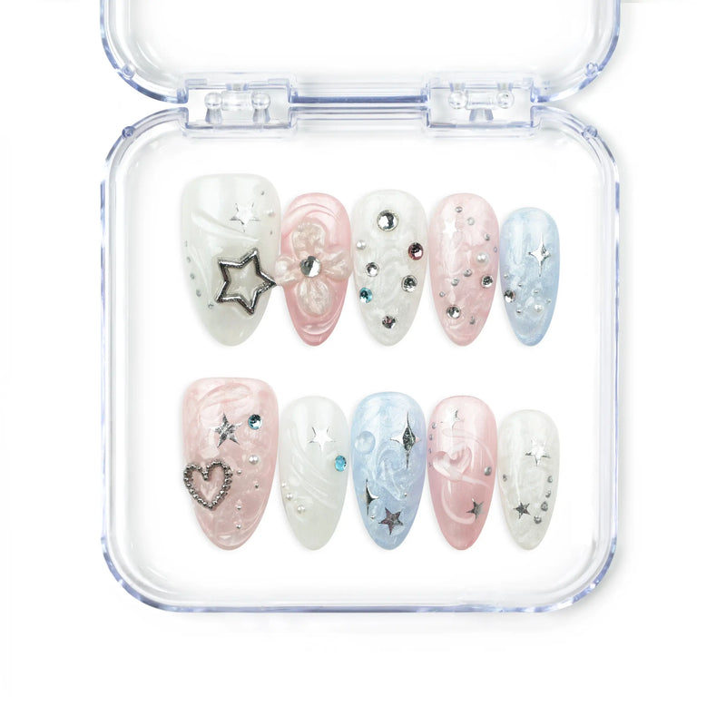 Naillover Starry Sweet Dream handmade press on nails with pearlescent pink, blue, and white base, decorated with 3D stars, pearls, heart, and rhinestones.