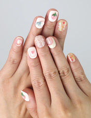 Hand gesture showing short soft pink press on nails with cute strawberry and heart nail art, handmade by Naillover in Singapore