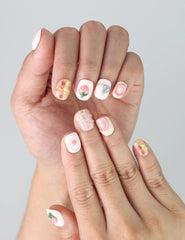 Naillover Singapore handmade nails featuring playful strawberry and heart patterns on a blush pink base, displayed on fingertips