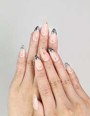 Hand model wearing Subtle Spark handmade Singapore press on nails in peach with silver stars
