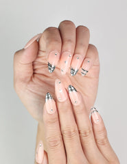 Close-up of Subtle Spark classic Singapore press on nails with delicate silver star accents