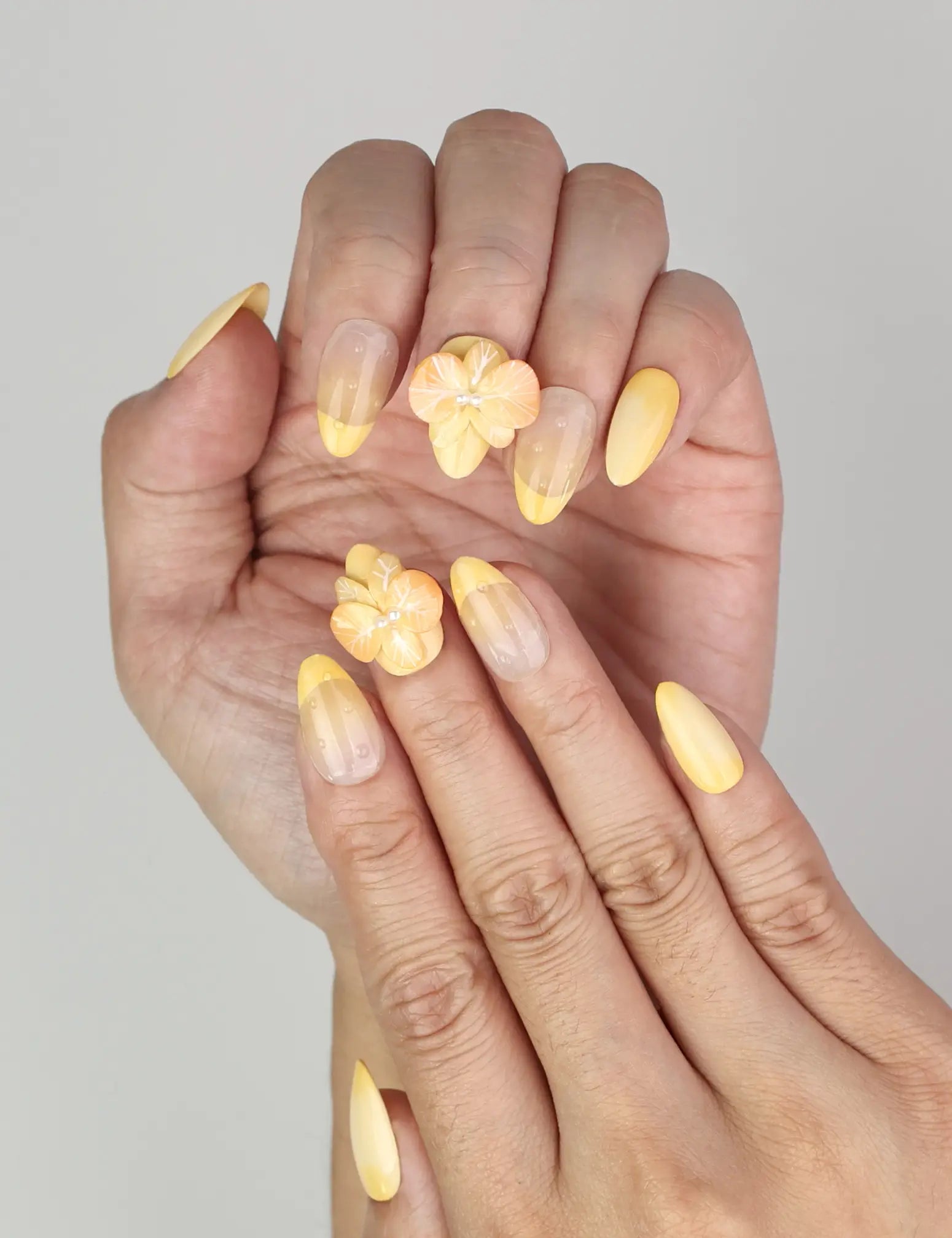 Close-up of Naillover Sunny Bloom Singapore press on nails showing delicate floral and pearl 3D accents.