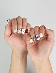 Side view of Vibrant Pop cute nails with ivory base, polka dots, and classic red lip accents.