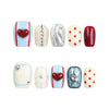 Vibrant Pop ivory base Singapore press-on nails with playful red lips and polka dot designs on white background.