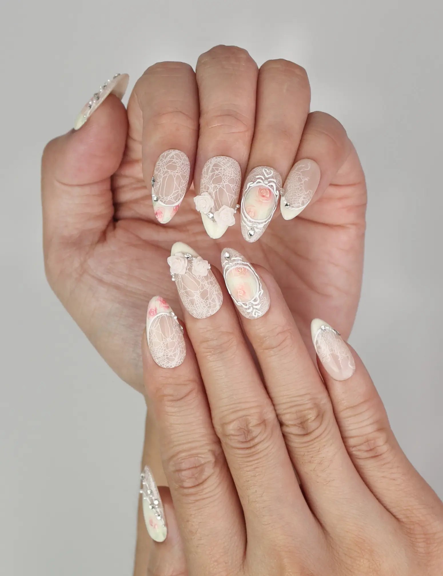 Close-up of Naillover Vintage Rose Lace Singapore press on nails with pearl and rhinestone accents.