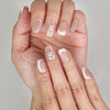 Close-up of Naillover Whisper Beige Singapore press on nails, showing soft gradient finish with delicate gemstone detail.