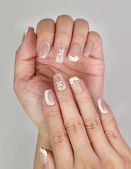 Close-up of Naillover Whisper Beige Singapore press on nails, showing soft gradient finish with delicate gemstone detail.