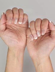 Naillover Whisper Beige simple nails styled on hand, featuring handmade gradient press on nails with subtle silver gemstone.