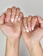 Naillover Whispering Petals in Pink Haze trendy nails styled on hand, featuring neutral base with sculpted blossoms.