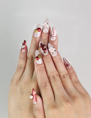 Model wearing Xmas Sparkle red and white press-on nails with festive bows, handmade Singapore nails by naillover