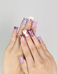 Hand wearing Y2K Purple Haze handmade Singapore press on nails by naillover, showing vibrant purple hues and linear designs.