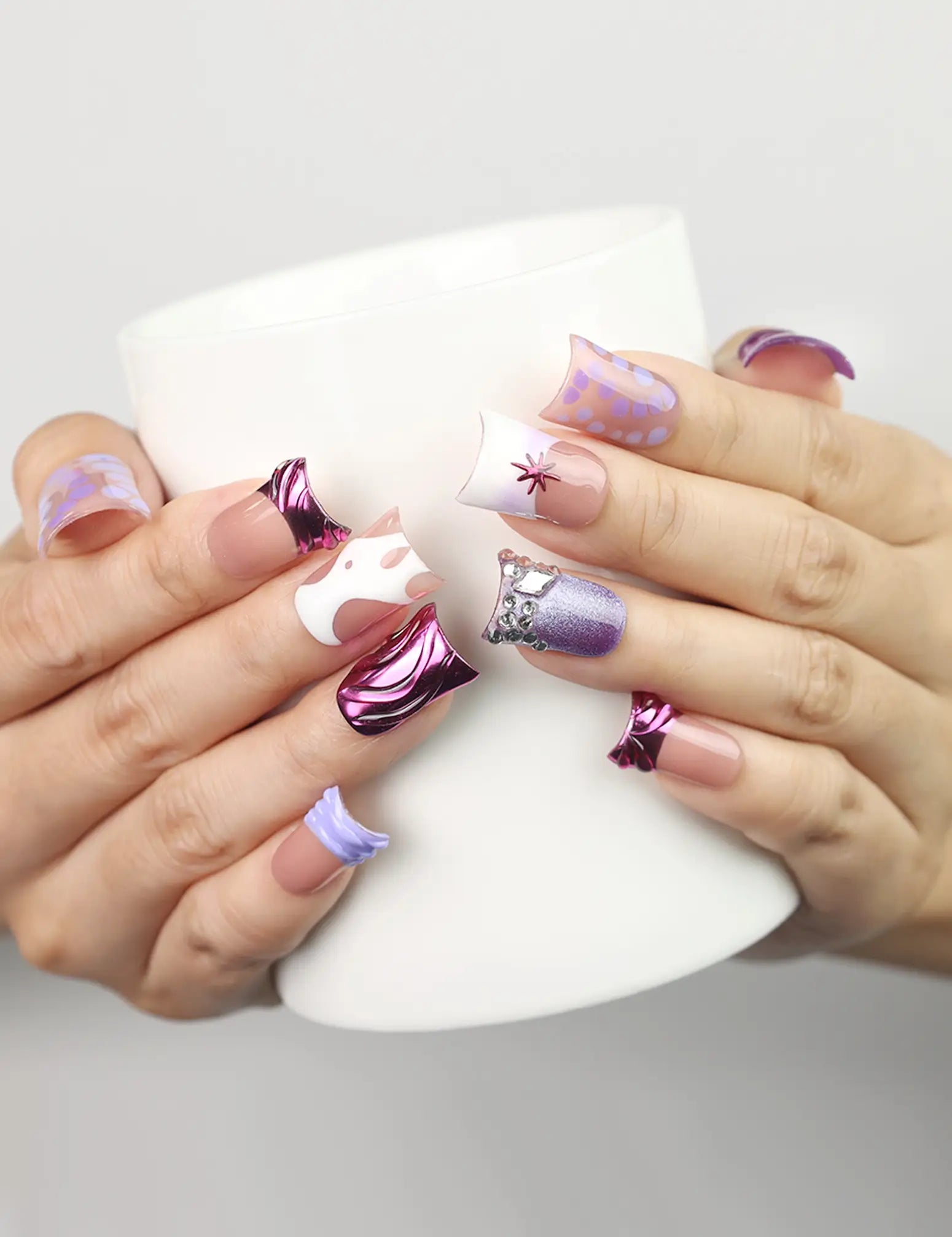 Model holding a cup while wearing Y2K Purple Haze handmade Singapore press on nails by naillover, showcasing the trendy Y2K purple design.